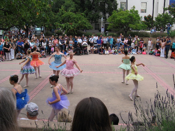 A large crowd gathered to watch a graceful ballet performance by talented youth.